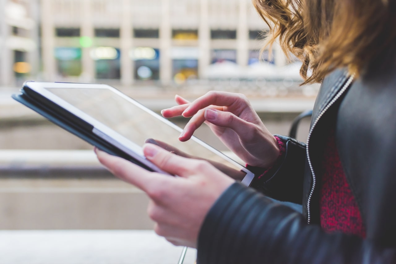 Woman making selection on tablet